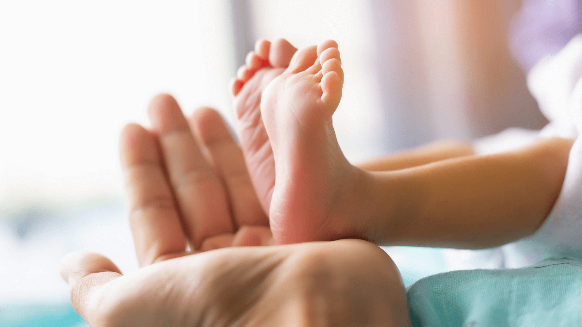 Babyfüße in einer Hand